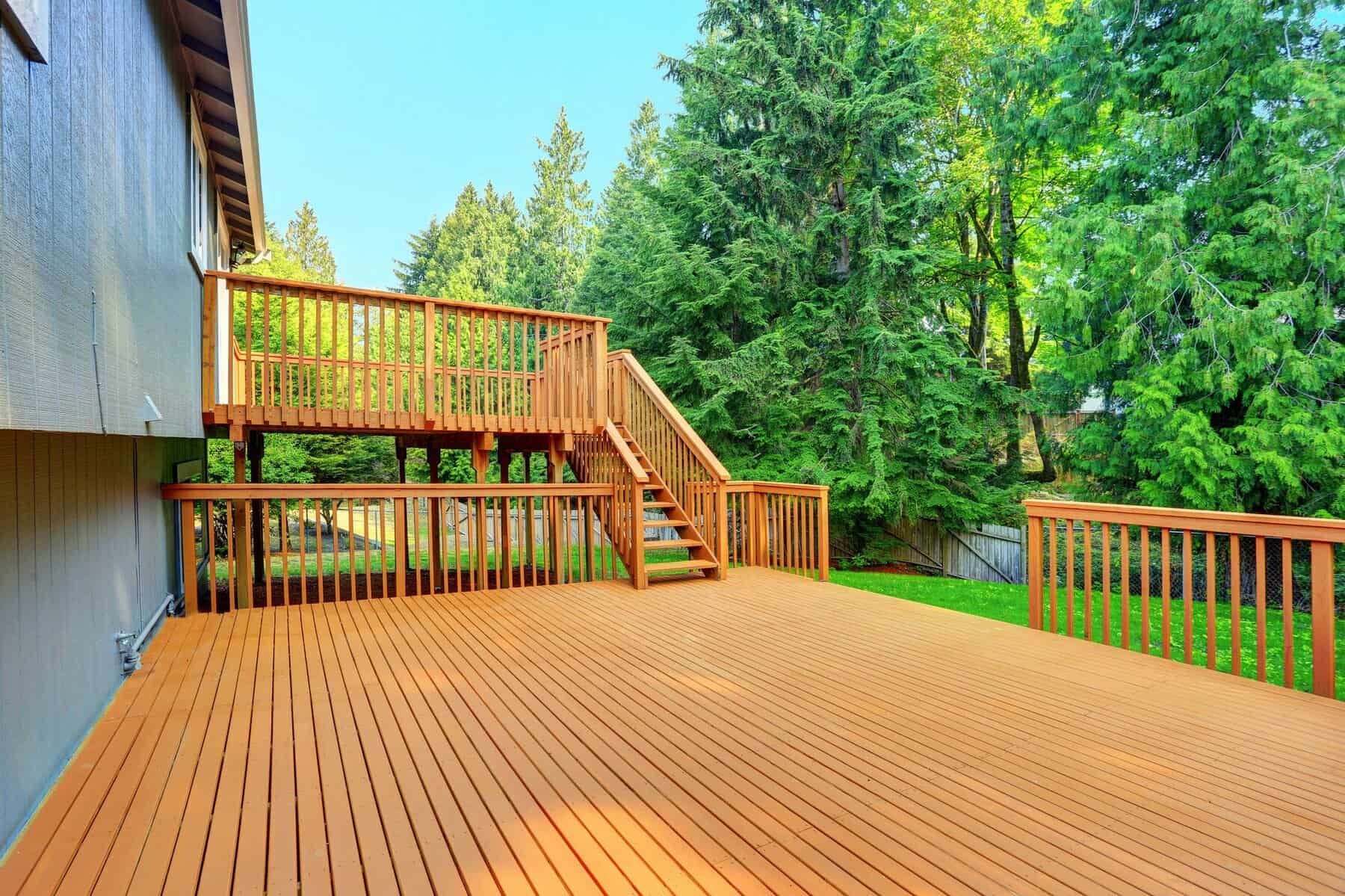 Cedar Painted Residential Deck Warm cedar-toned painted deck with wooden railings and stairs adjoining residential home in Nashville.